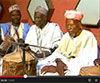 Group of men with traditional instruments, still from video